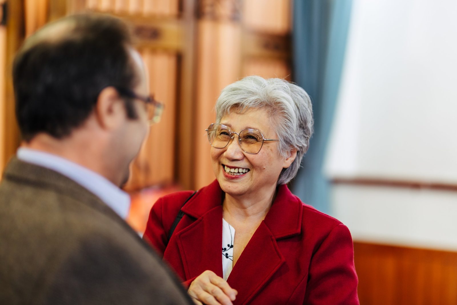 Two members of the congregation chatting and smiling